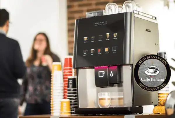AdmiralVending-CommercialCoffeeMachines-HeaderMobile220526 Admiral Vending - Commercial Coffe Machines - Image of coffee machine in office with man and woman standing to side enjoying a cup of coffee